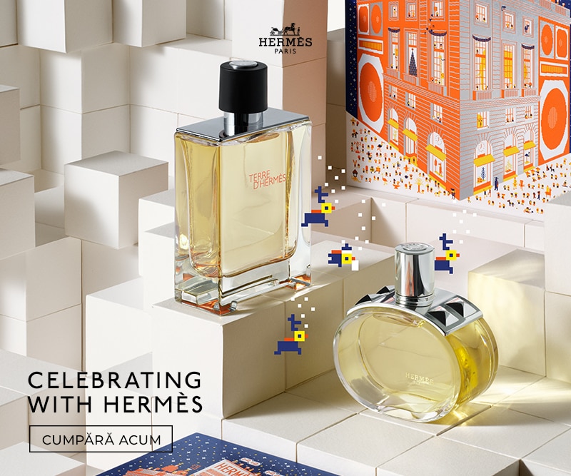 Parfum Hermès Terre d’Hermès în sticlă elegantă, prezentat pe fundal geometric alb, alături de cutie cadou colorată, imagine premium pentru cumpărături online.